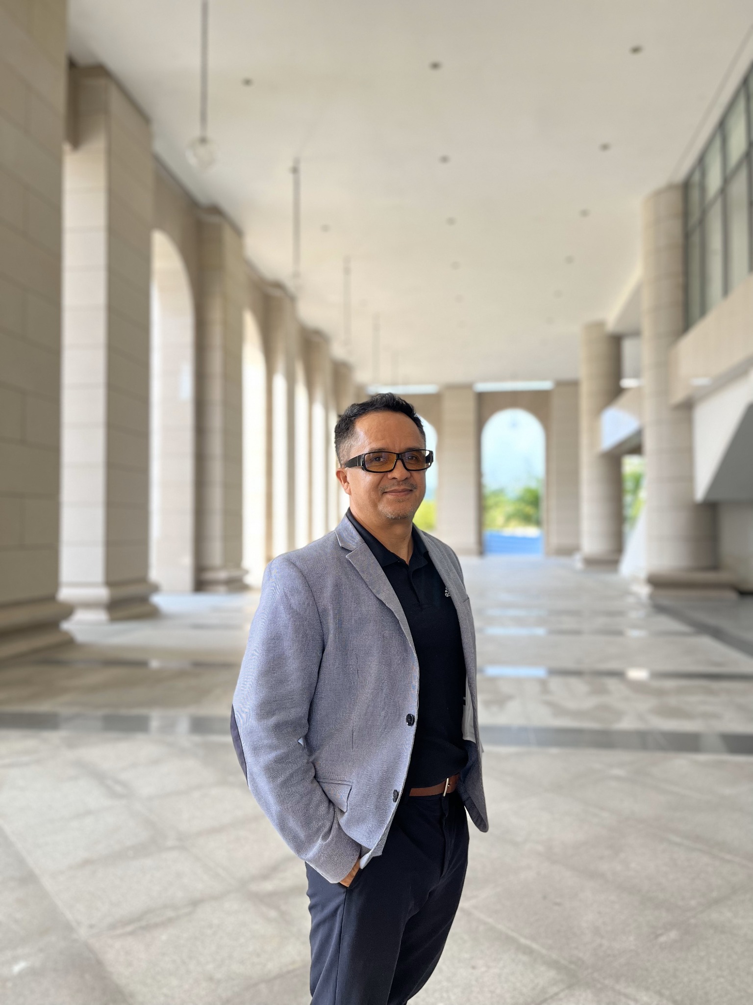 Luis M. Pazos in an architectural colonnade